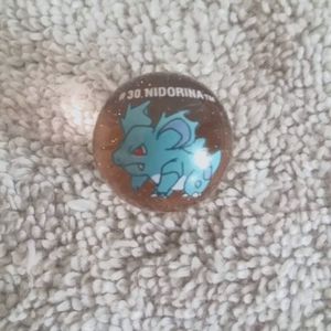 Pokemon marbles #30 Nidorina on light peach clear glass base shooter